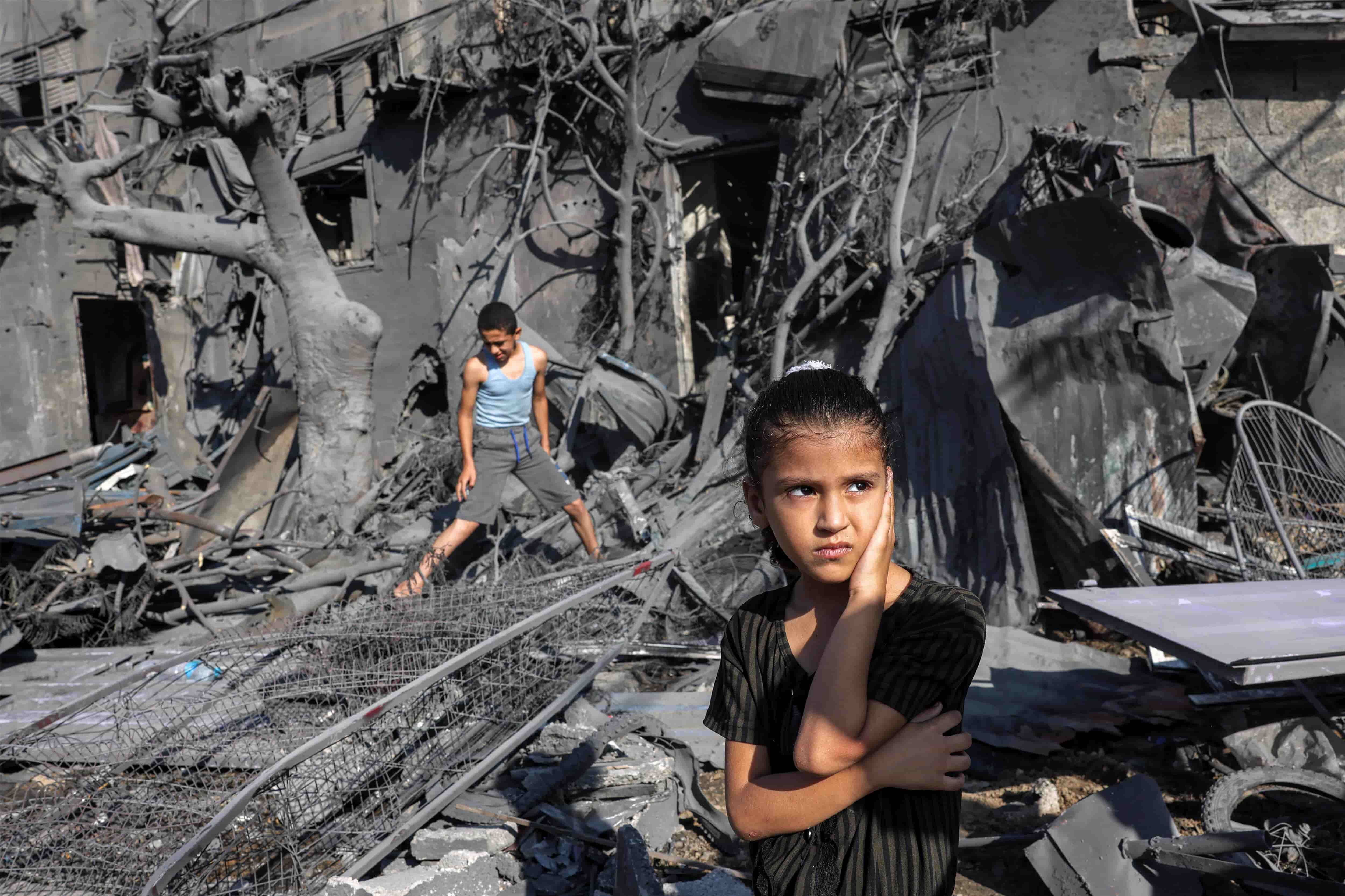 A girl looks on as she stands by the rubble outside a building that was hit by Israeli bombardment in Rafah in the southern Gaza Strip this morning.Photograph: Mohammed Abed/AFP/Getty Images