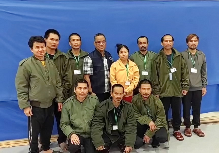 1 of 4 | In this photo provided by Thailands Foreign Ministry, ten of freed Thai hostages and an officer, fourth from left